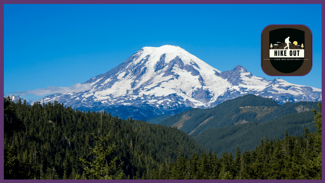 A clear, bright view of Mount Rainier towering above the landscape with lush green forests and the skyline stretching in the distance.